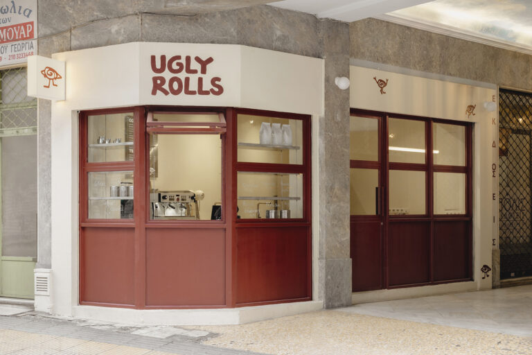 ArchiSearch: Georgios Apostolopoulos designs Ugly Rolls, a tiny corner shop in Athens with cinnamon-toned maroon framingv